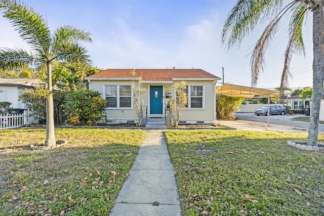 view of front of property with an attached carport, fence, driveway, a front lawn, and crawl space