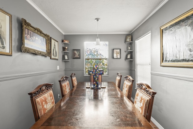 dining area featuring a wealth of natural light, a textured ceiling, and crown molding