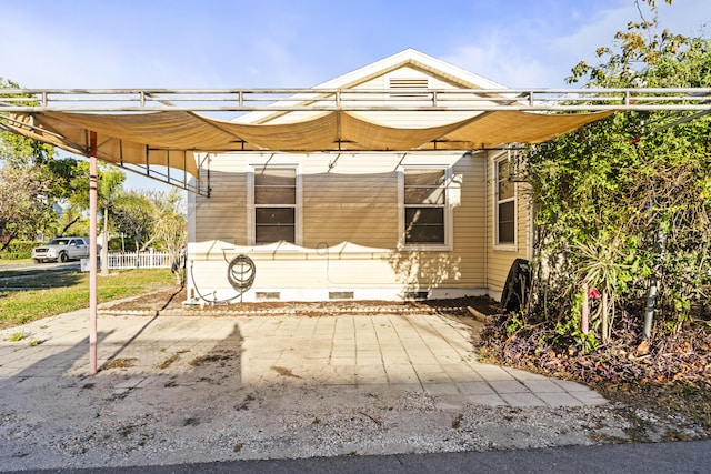 view of patio / terrace featuring a carport and fence