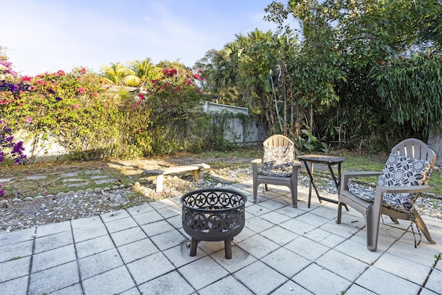 view of patio with fence and an outdoor fire pit