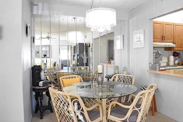 dining space featuring a textured ceiling and carpet