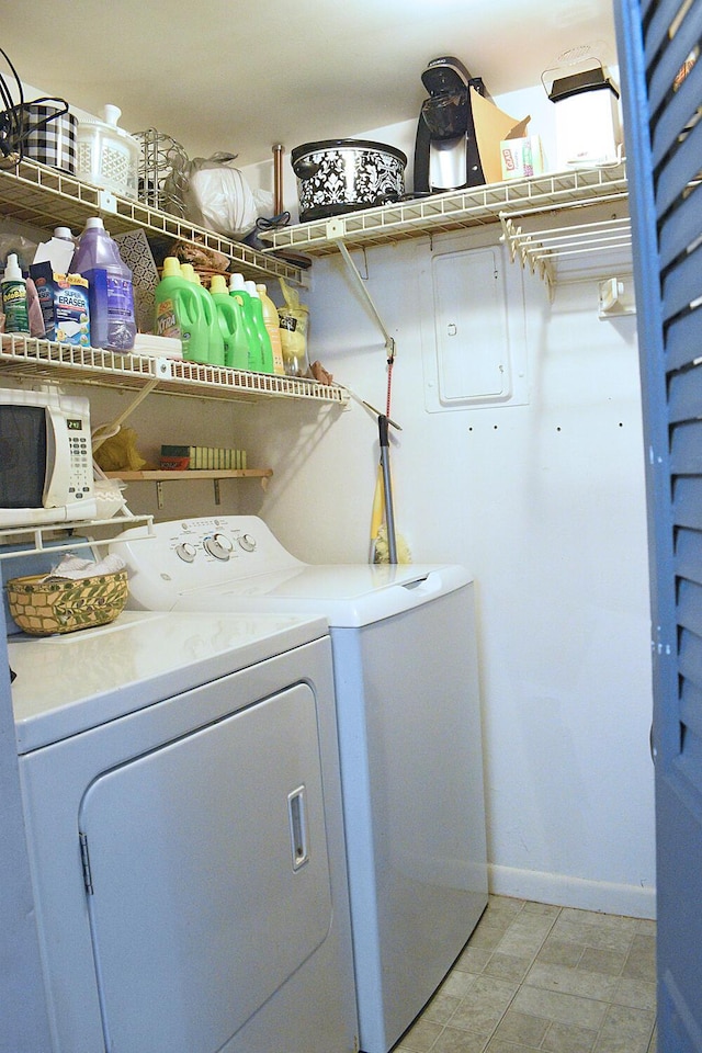 laundry area featuring baseboards, separate washer and dryer, and laundry area