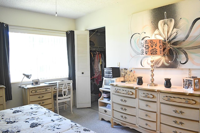 bedroom featuring a closet, a textured ceiling, and carpet