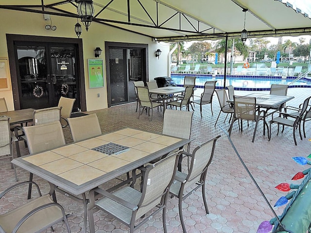 view of patio / terrace with outdoor dining area and a community pool