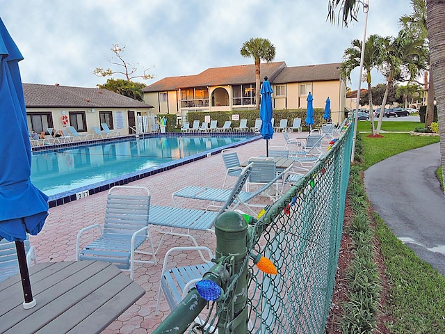 community pool featuring a patio area and fence