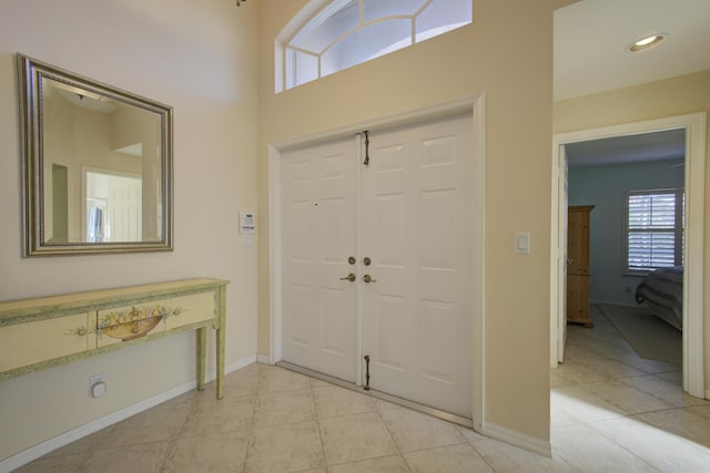 entrance foyer featuring light tile patterned floors and baseboards