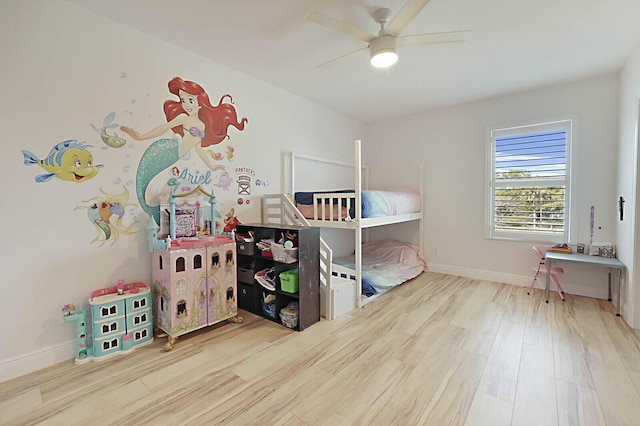 bedroom featuring wood finished floors, baseboards, and ceiling fan