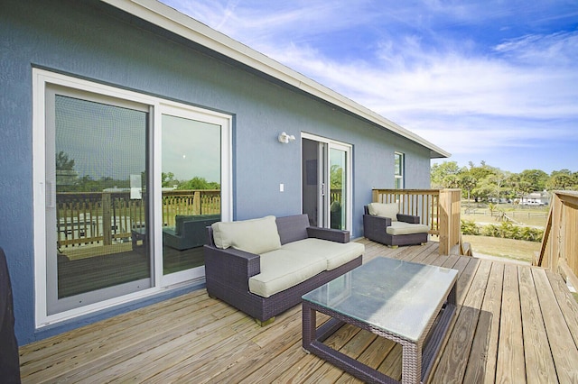 wooden deck with an outdoor living space