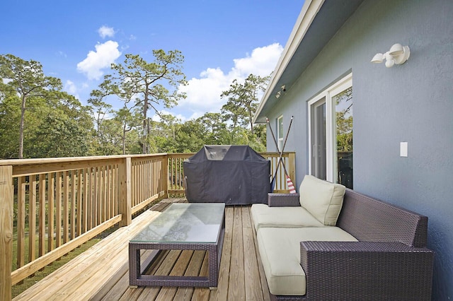 wooden terrace featuring a grill and outdoor lounge area