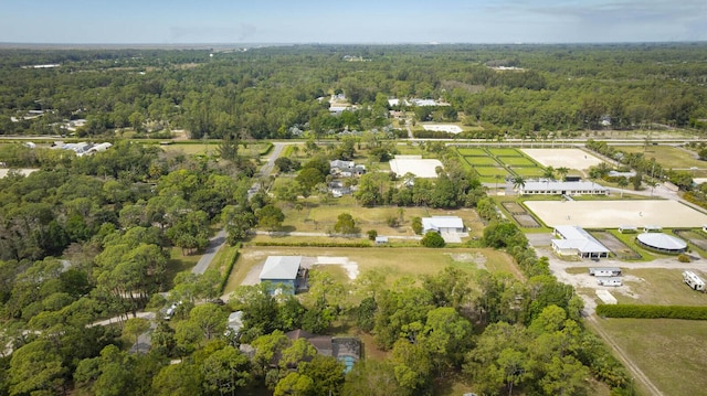 birds eye view of property featuring a forest view