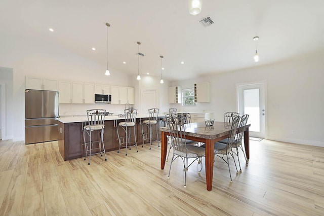 dining area featuring visible vents, high vaulted ceiling, light wood-style flooring, recessed lighting, and baseboards