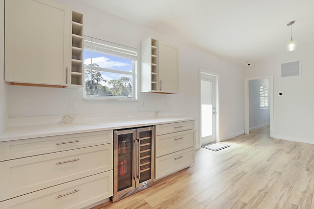 kitchen featuring visible vents, a healthy amount of sunlight, wine cooler, light wood-type flooring, and open shelves