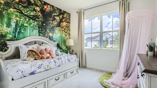 bedroom featuring light carpet, multiple windows, and baseboards