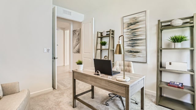 carpeted home office featuring visible vents and baseboards