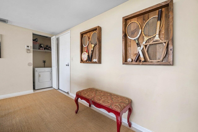 corridor featuring visible vents, washer / dryer, baseboards, and carpet