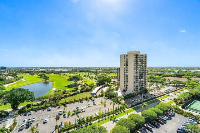 birds eye view of property with view of golf course and a water view