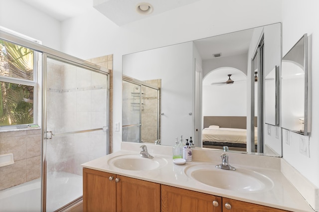 full bathroom featuring connected bathroom, a healthy amount of sunlight, and a sink