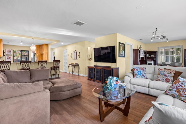 living room with visible vents, plenty of natural light, and wood finished floors