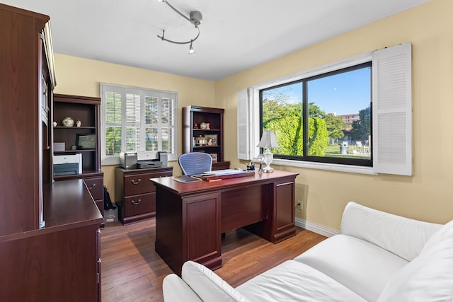 home office featuring baseboards and dark wood-style flooring