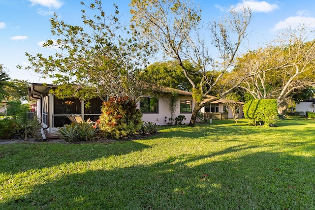 view of yard featuring a sunroom