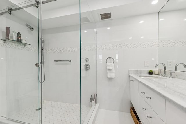 full bathroom with visible vents, a stall shower, and vanity