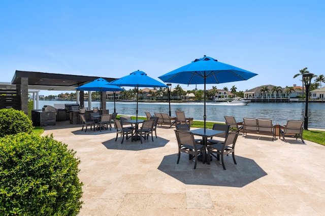 view of patio with outdoor dining space and a water view