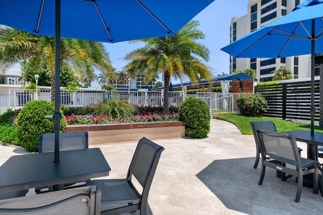 view of patio featuring outdoor dining area and fence