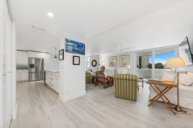 living area featuring visible vents, baseboards, ceiling fan, recessed lighting, and light wood-style flooring