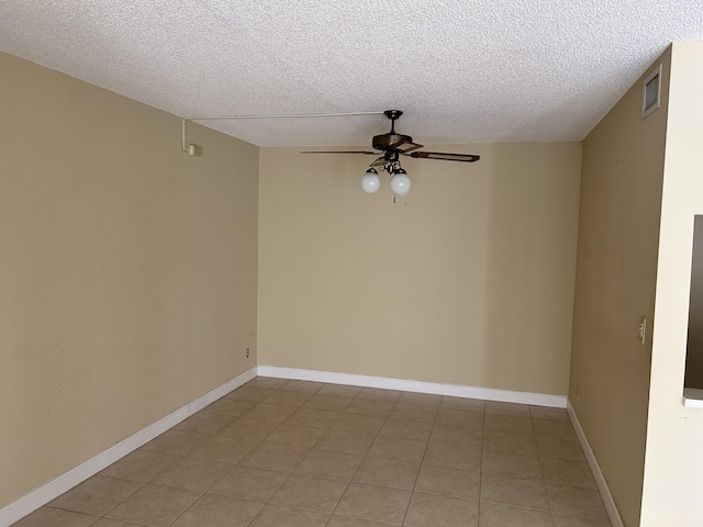 unfurnished room featuring visible vents, baseboards, a textured ceiling, and ceiling fan