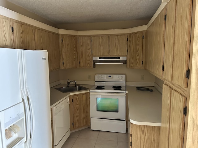 kitchen featuring under cabinet range hood, a sink, a textured ceiling, white appliances, and light tile patterned floors