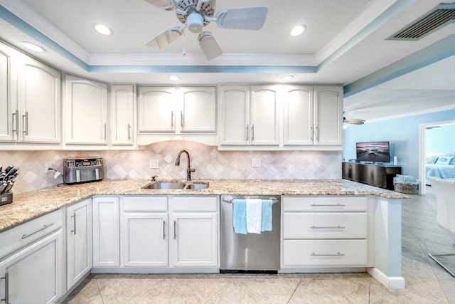 kitchen with dishwasher, a raised ceiling, visible vents, and a sink