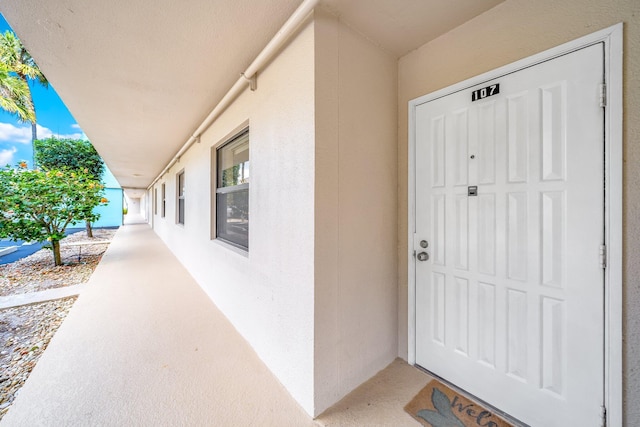 view of exterior entry with stucco siding