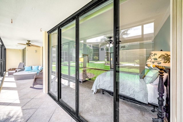 doorway with a wealth of natural light, ceiling fan, and floor to ceiling windows