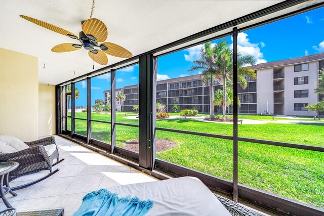 sunroom featuring ceiling fan