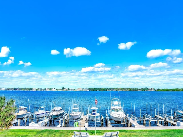 dock area with a water view and boat lift