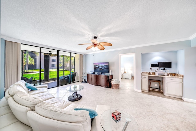 living area featuring a textured ceiling, ceiling fan, and crown molding