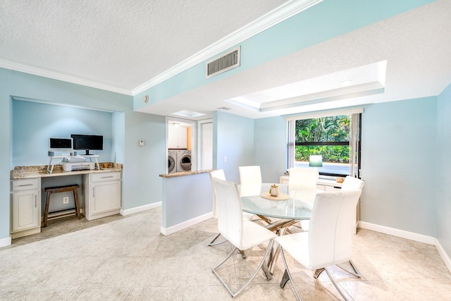 dining space with a textured ceiling, visible vents, independent washer and dryer, and ornamental molding