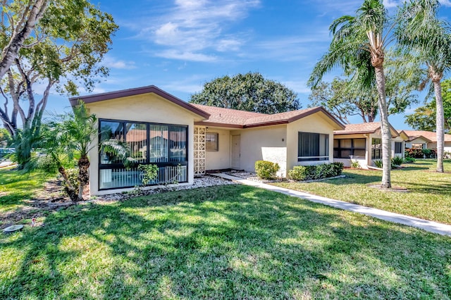 view of front of home featuring a front lawn and stucco siding