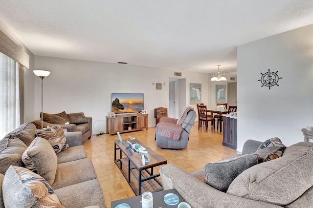 living area with visible vents and a textured ceiling