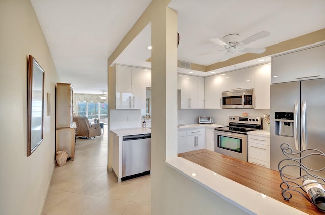 2901 Victoria Cir Unit L4, Coconut Creek, FL 33066 - kitchen featuring appliances with stainless steel finishes, ceiling fan, light countertops, light tile patterned floors, and white cabinets