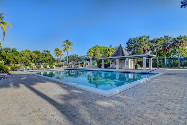 community pool featuring a patio area and fence