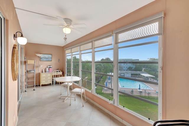 sunroom / solarium with plenty of natural light and ceiling fan