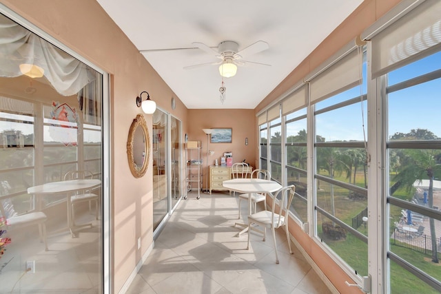 sunroom / solarium with a ceiling fan