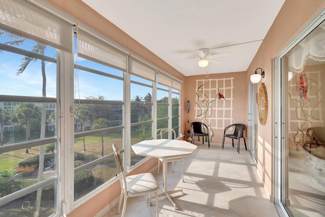 sunroom / solarium featuring ceiling fan