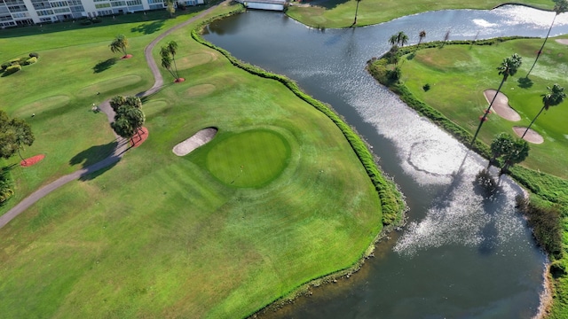 bird's eye view featuring view of golf course and a water view