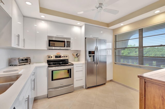 2901 Victoria Cir Unit L4, Coconut Creek, FL 33066 - kitchen with appliances with stainless steel finishes, white cabinetry, light countertops, light tile patterned flooring, and recessed lighting