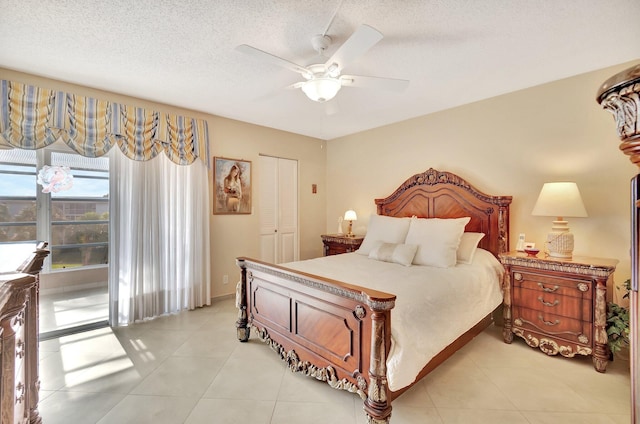 bedroom with access to outside, light tile patterned floors, a ceiling fan, and a textured ceiling