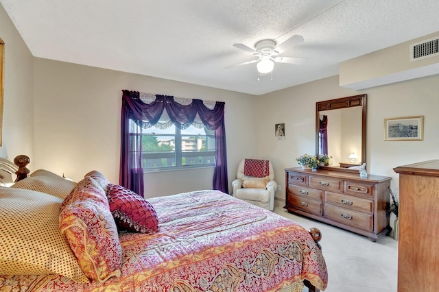 bedroom featuring visible vents, a textured ceiling, and ceiling fan