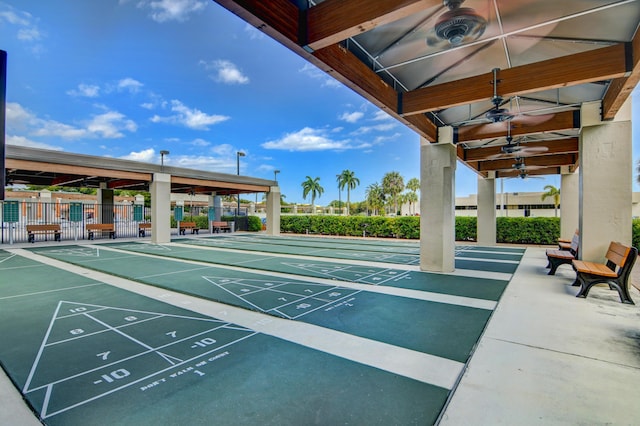 surrounding community featuring shuffleboard and fence