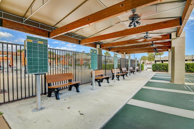 view of home's community with shuffleboard and fence